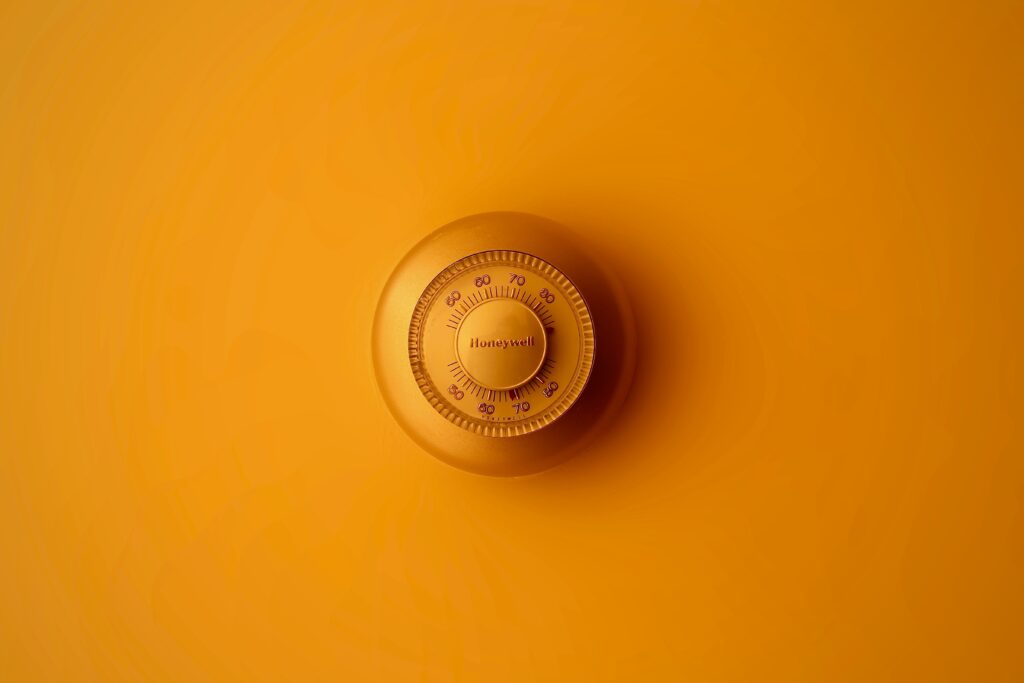 thermostat on yellow wall